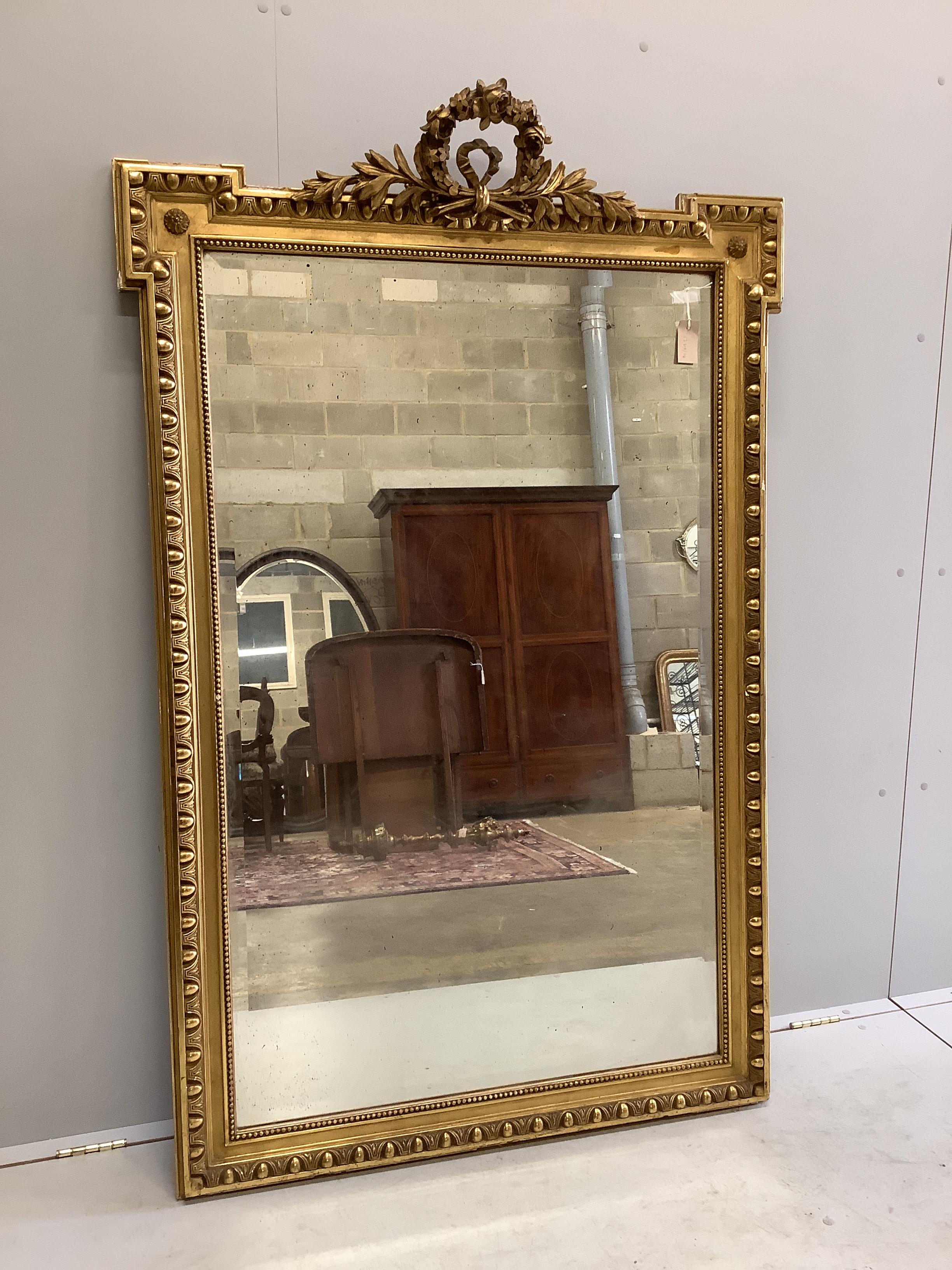 A 19th century French giltwood and composition wall mirror, with floral scroll pediment, width 107cm, height 166cm